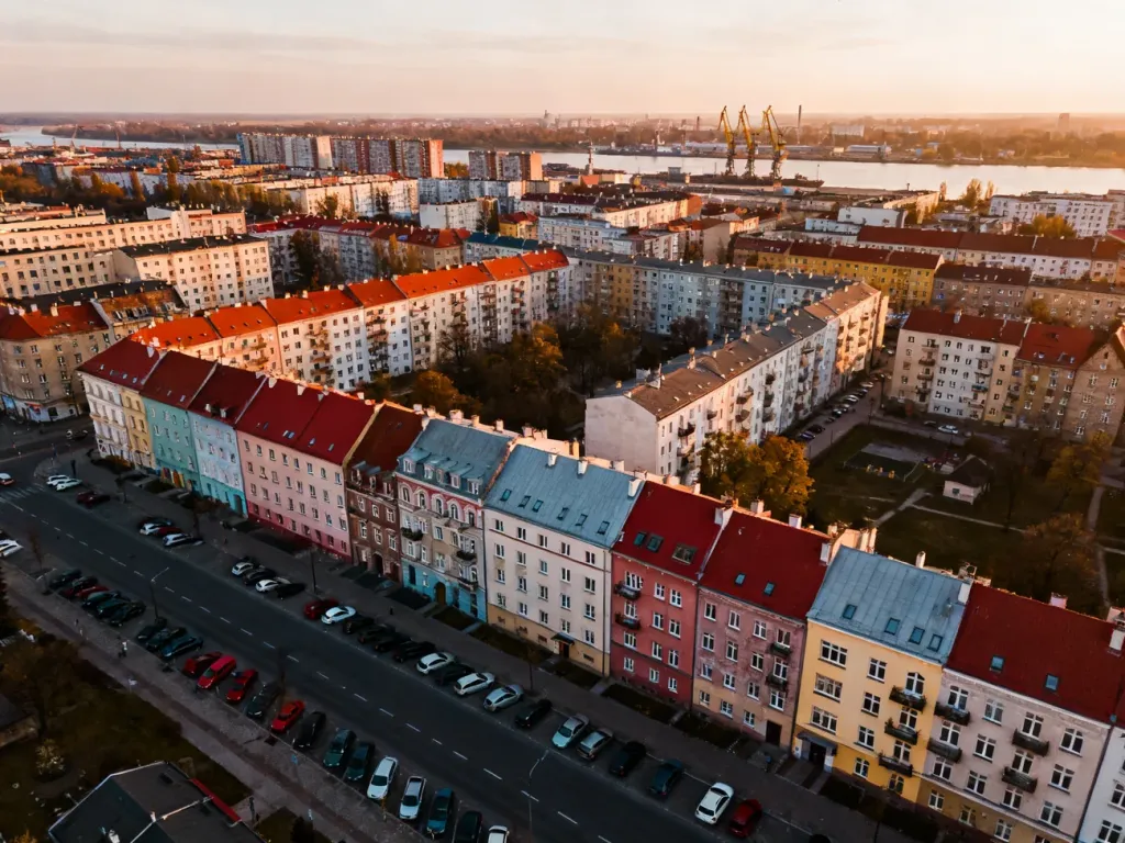 Panorama centrum Szczecina z kolorowymi blokami mieszkalnymi, pokazująca skalę rynku mieszkaniowego; no text on the picture